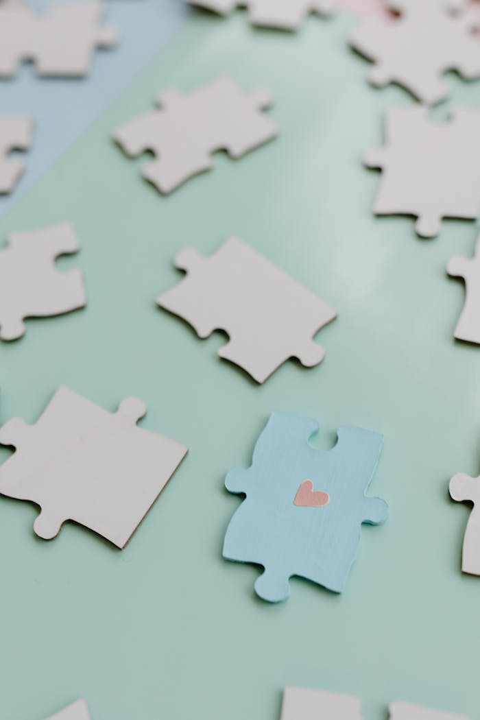 Jigsaw Puzzle Pieces over White Table